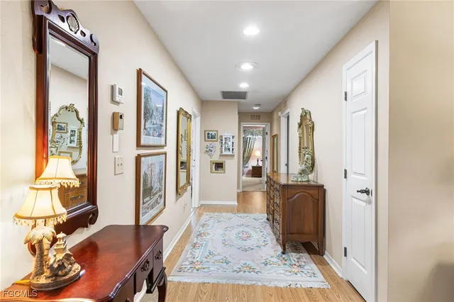 a view of a hallway with furniture and windows