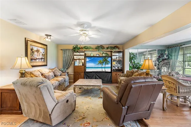 a living room with furniture ceiling fan and a rug