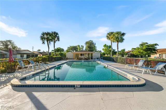 a view of swimming pool with outdoor seating and plants