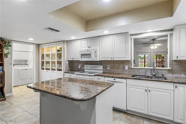 a kitchen with stainless steel appliances granite countertop a sink stove and cabinets