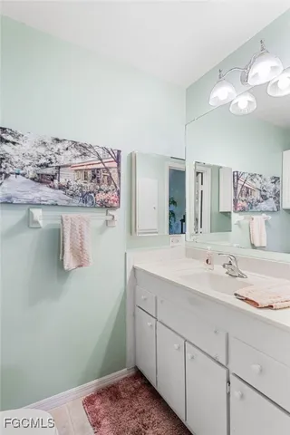 a bathroom with a sink a vanity and mirror