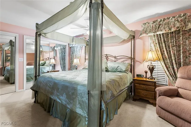 a bedroom with a bed next to a large window with balcony view