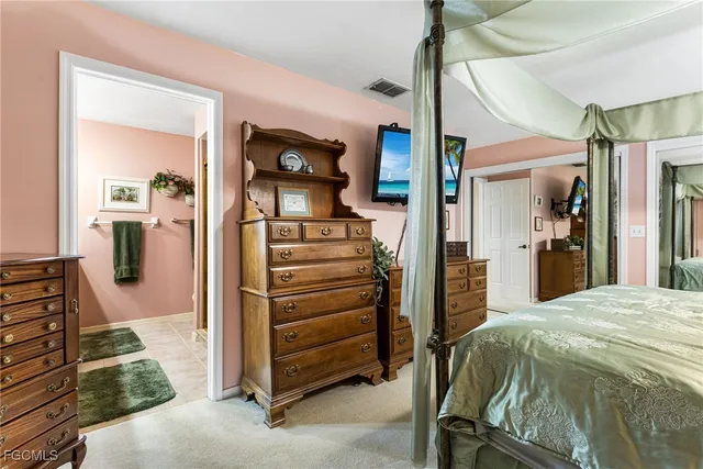 a bedroom with a bed and a mirror