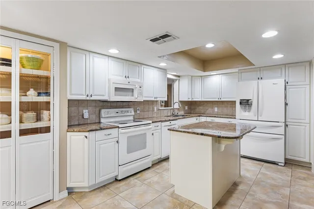 a kitchen with a sink window and cabinets
