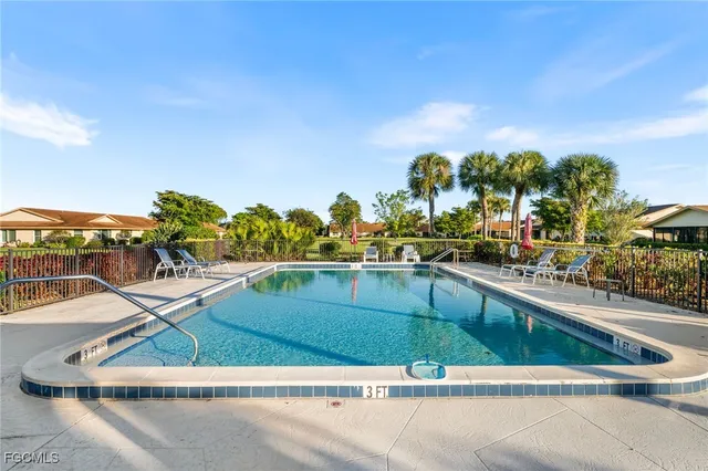 a view of a swimming pool with an outdoor seating and a floor to ceiling window