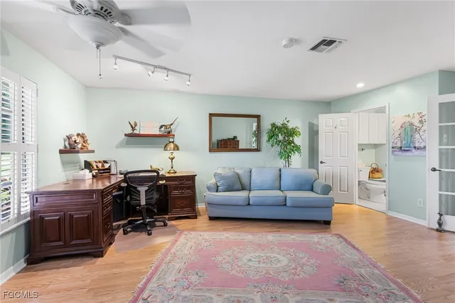 a living room with furniture and a dining table