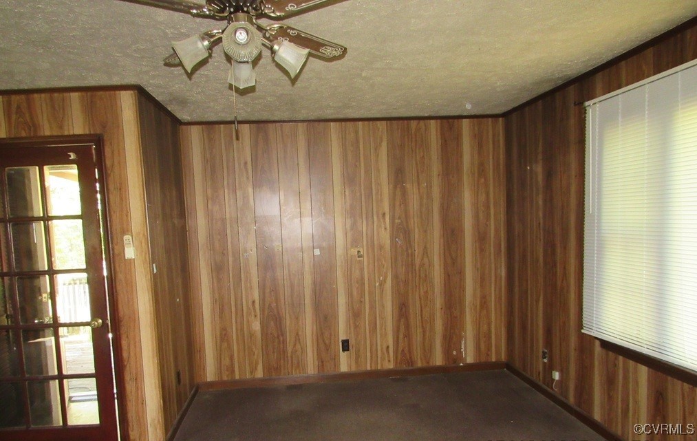 27701 Prince Edward Highway Rice, VA 23966 - Photo 9 of 21 Carpeted empty room featuring wood walls, a ceilin