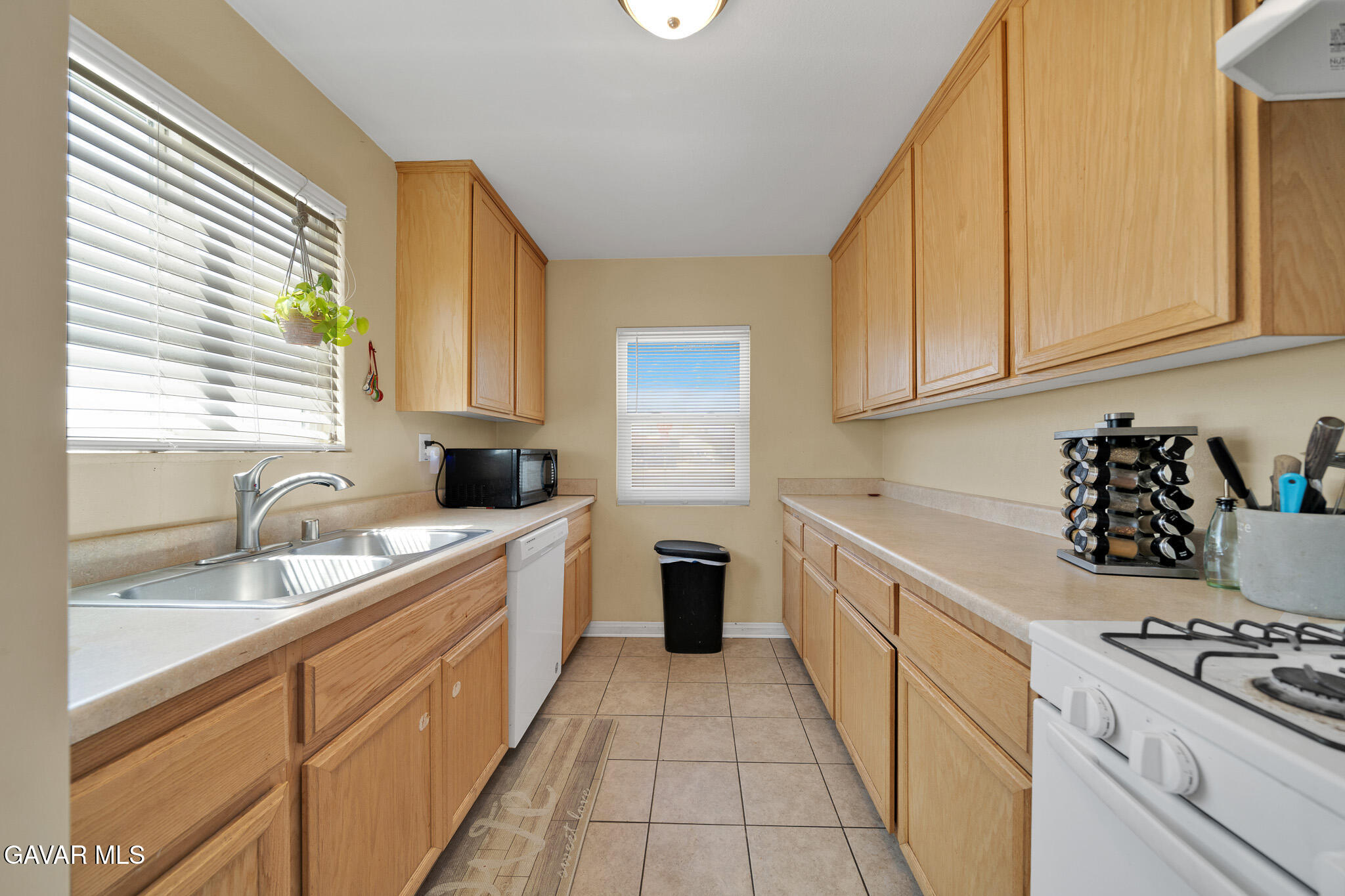 44188 Glenraven Road Lancaster, CA 93535 - Photo 7 of 26 a kitchen with a sink stove and cabinets