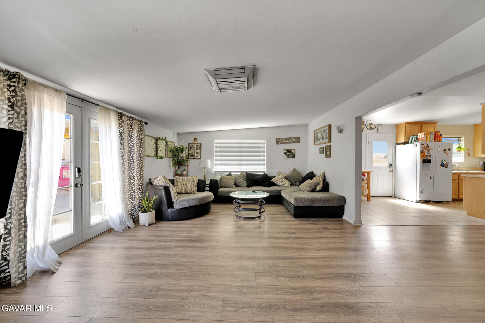 44188 Glenraven Road Lancaster, CA 93535 - Photo 10 of 26 a living room with furniture and a wooden floor