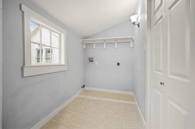 a bathroom with a tub shower and a window