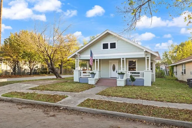 a view of a house with a yard and sitting area