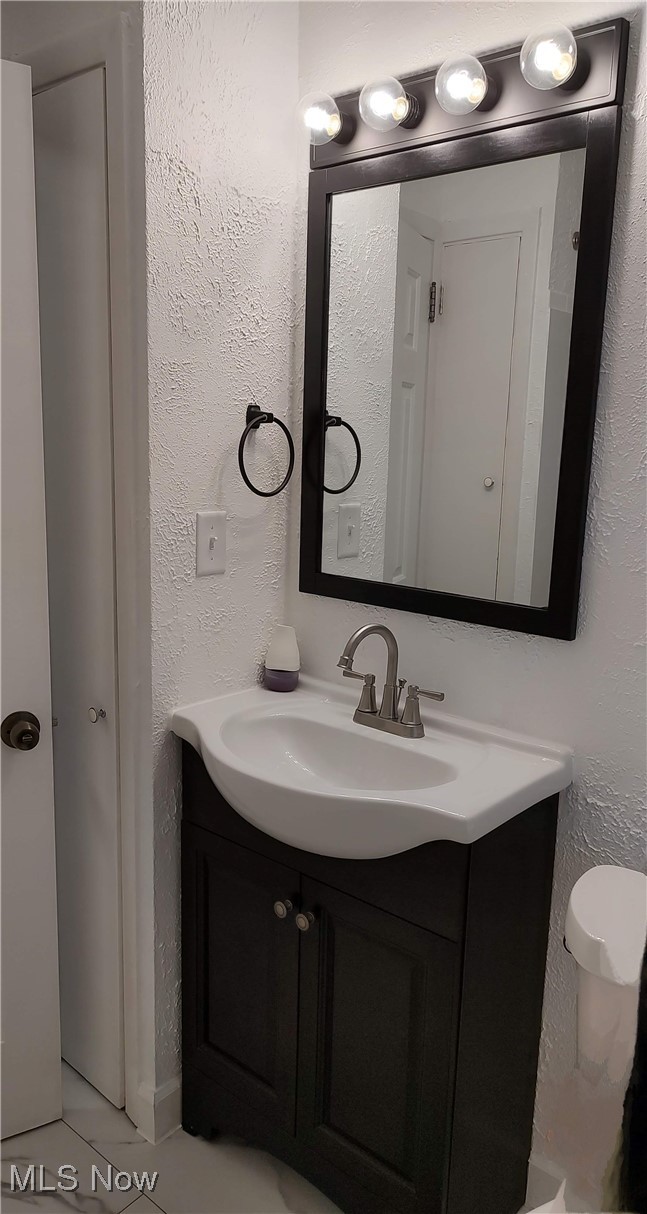 1750 Trinity Road Madison, OH 44057 - Photo 18 of 28 Bathroom with vanity, a textured wall, and toilet