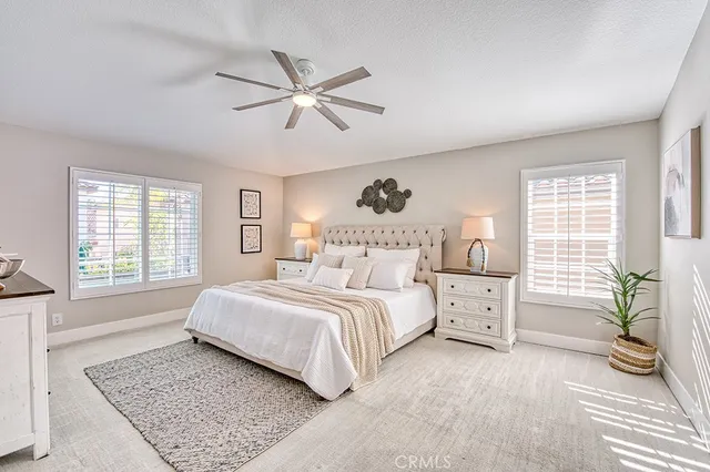 a spacious bedroom with a large bed and a window