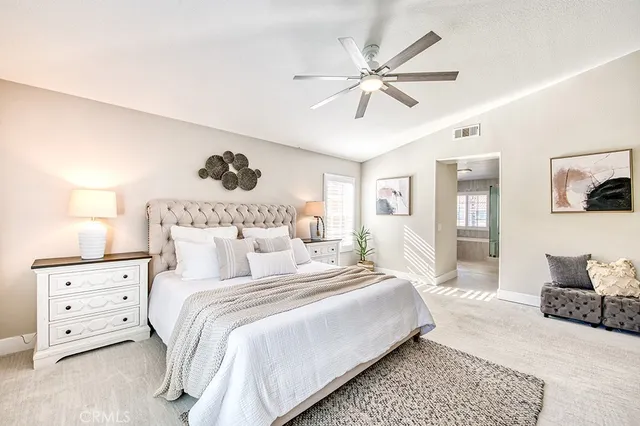 a bedroom with a large bed and a couch