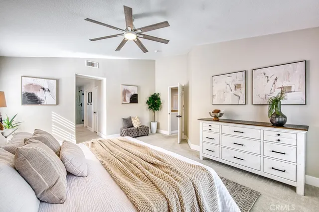 a bedroom with a bed and ceiling fan