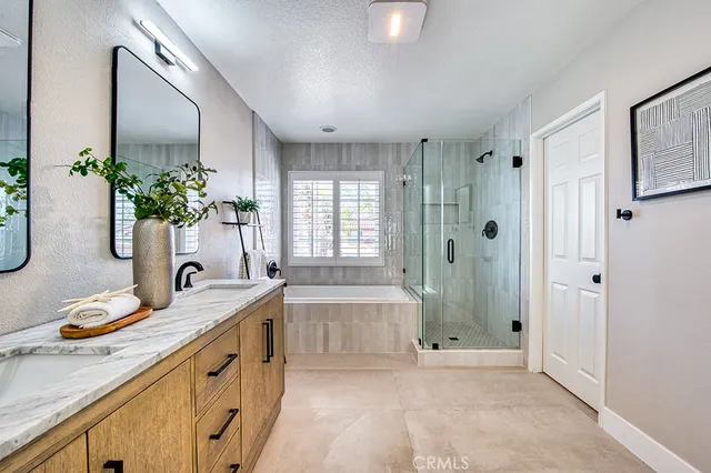 a spacious bathroom with a granite countertop tub sink and mirror