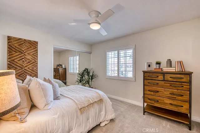 a bedroom with a bed and a potted plant