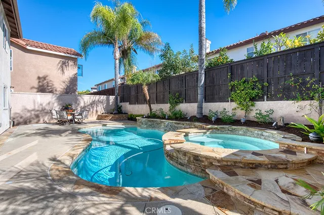 a view of a backyard with furniture and plants