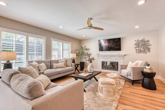 a living room with furniture a fireplace and a flat screen tv