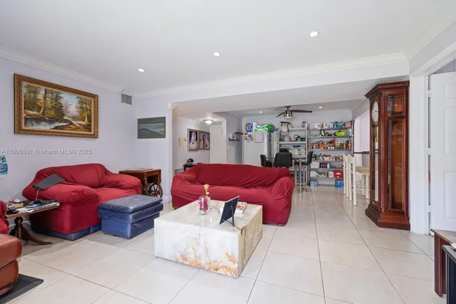 a living room with furniture a red couch and a window