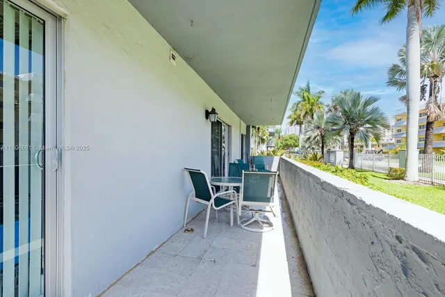 a view of a chairs and table in the balcony