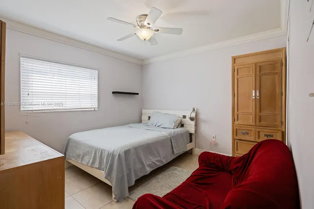 a bedroom with a bed couch and a window