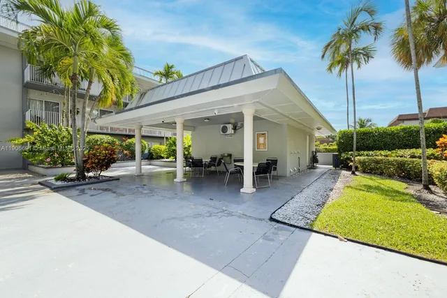 a view of a house with backyard porch and sitting area
