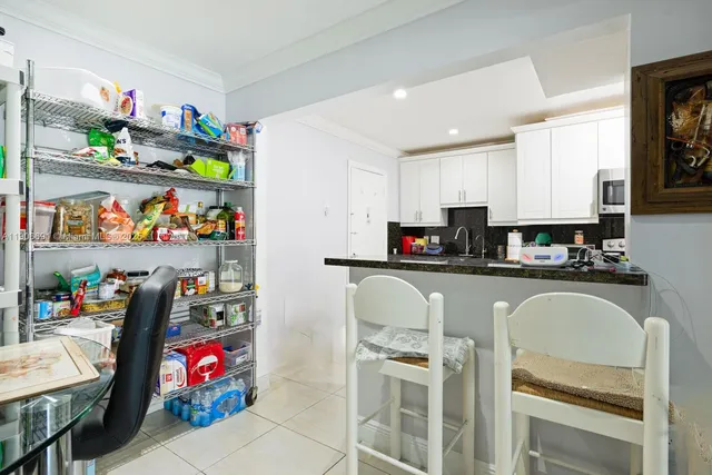 a kitchen with granite countertop lots of clutter and stainless steel appliances