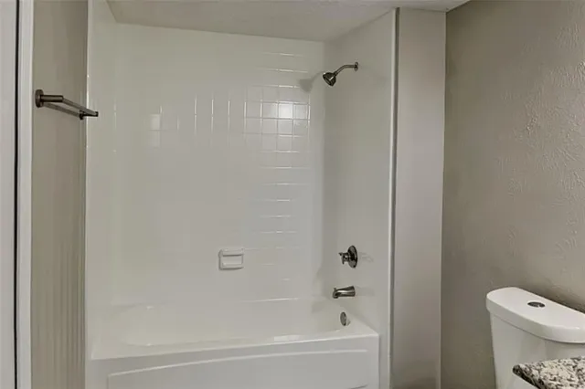 a bathroom with a bathtub and a toilet