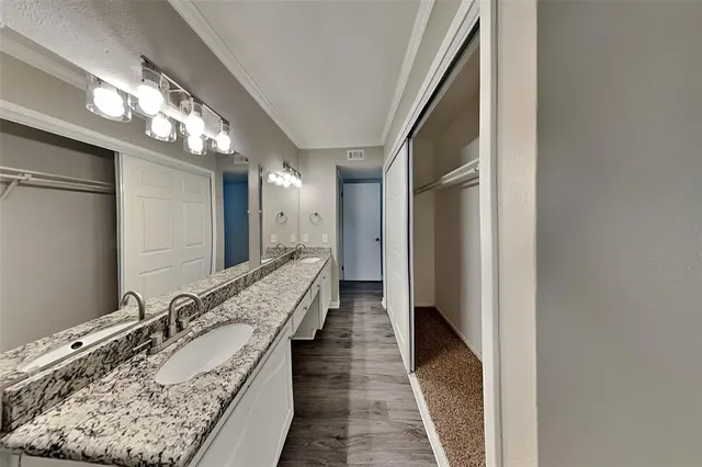 a hallway with mirror and stairs