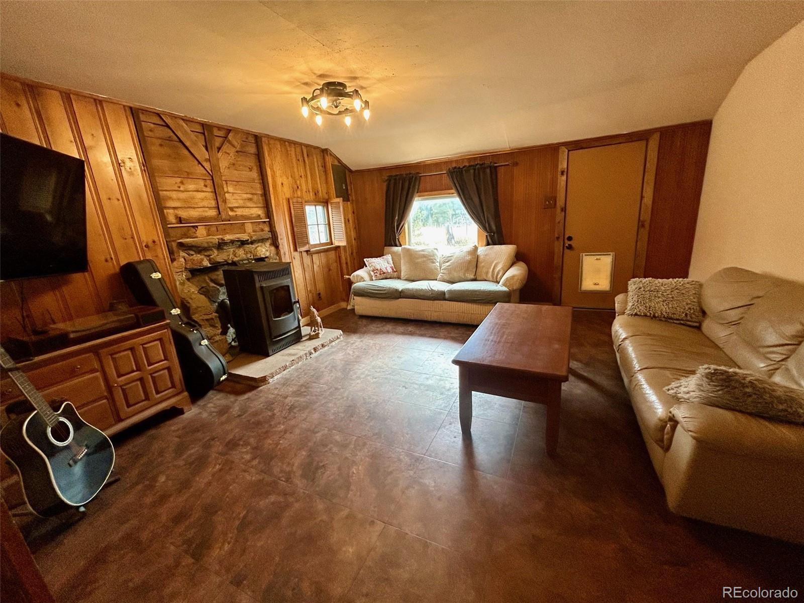27 Gap Road Black Hawk, CO 80422 - Photo 3 of 18 a living room with furniture and a flat screen tv