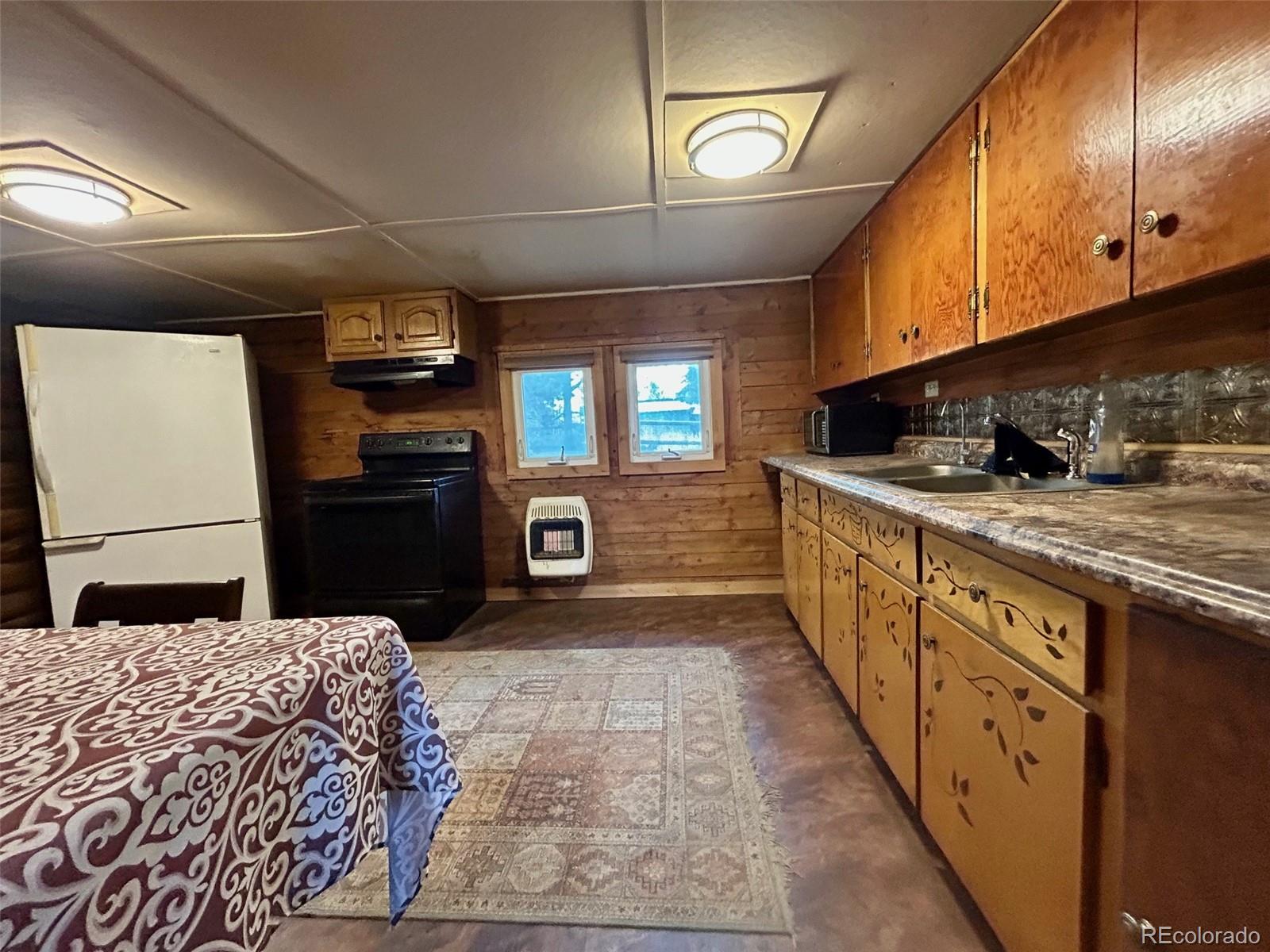 27 Gap Road Black Hawk, CO 80422 - Photo 6 of 18 a kitchen with stainless steel appliances granite countertop a sink a stove and a wooden cabinets