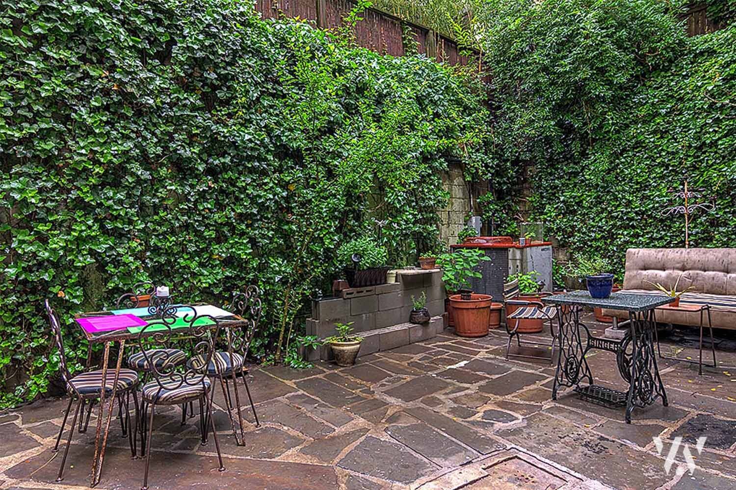 363 West 19th Street, Unit R Manhattan, NY 10011 - Photo 3 of 7 an outdoor sitting area with a table and chairs