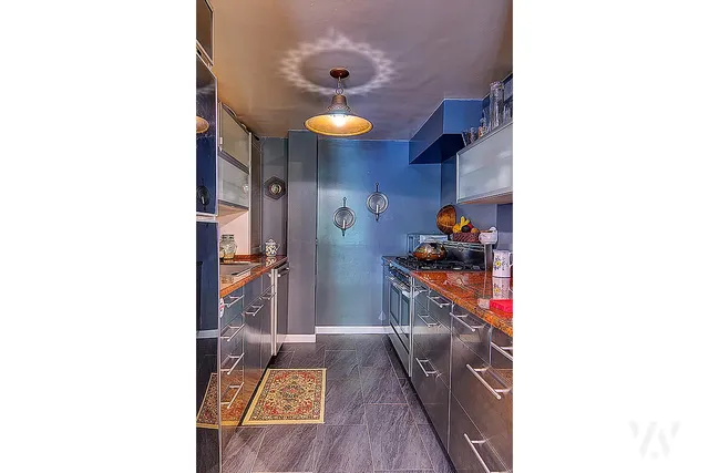 a hallway with a large mirror and cabinets