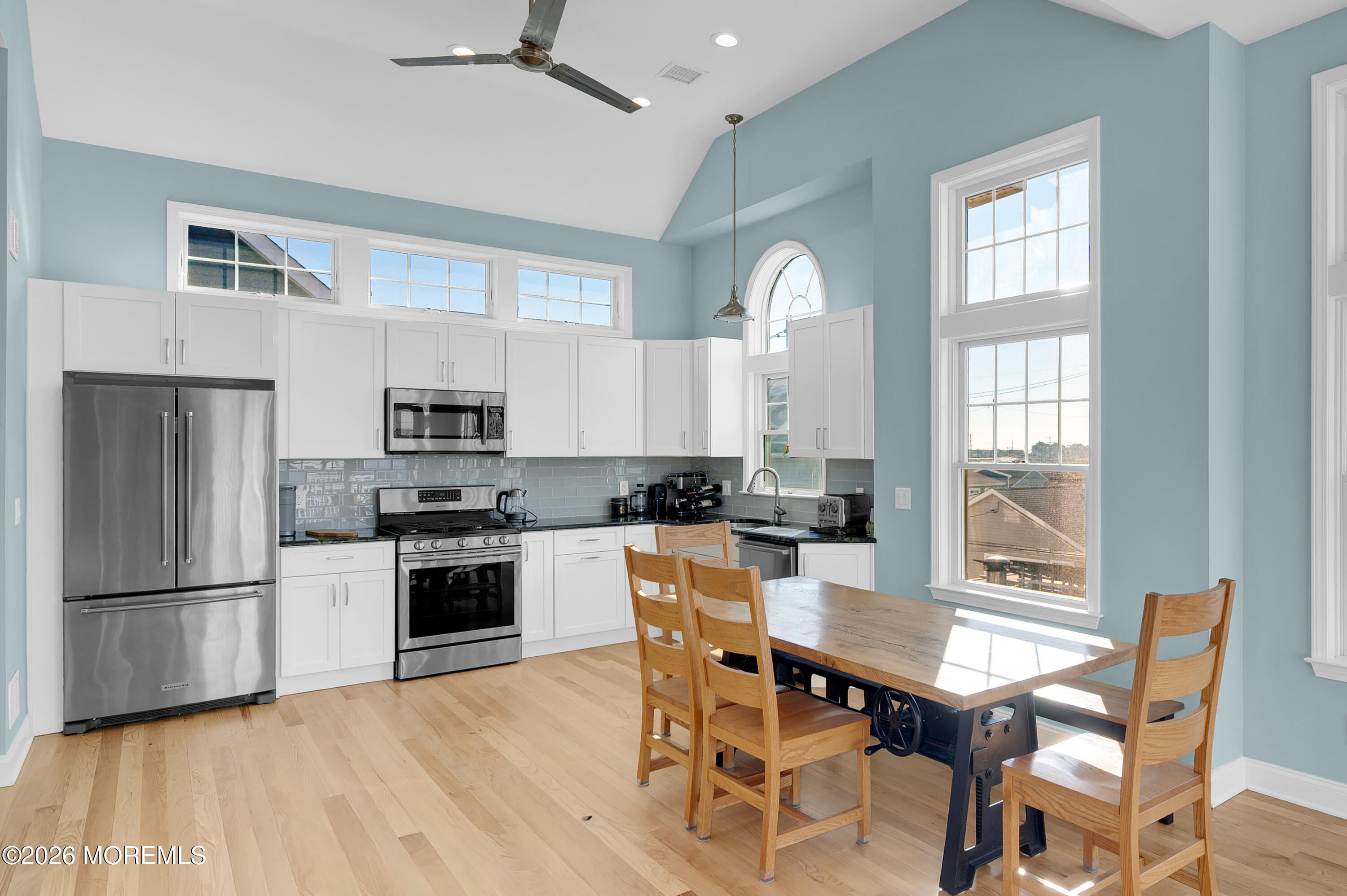 170 West Beach Way Lavallette, NJ 08735 - Photo 11 of 71 a kitchen with stainless steel appliances granite countertop a stove a refrigerator a sink dishwasher a dining table and chairs with wooden floor