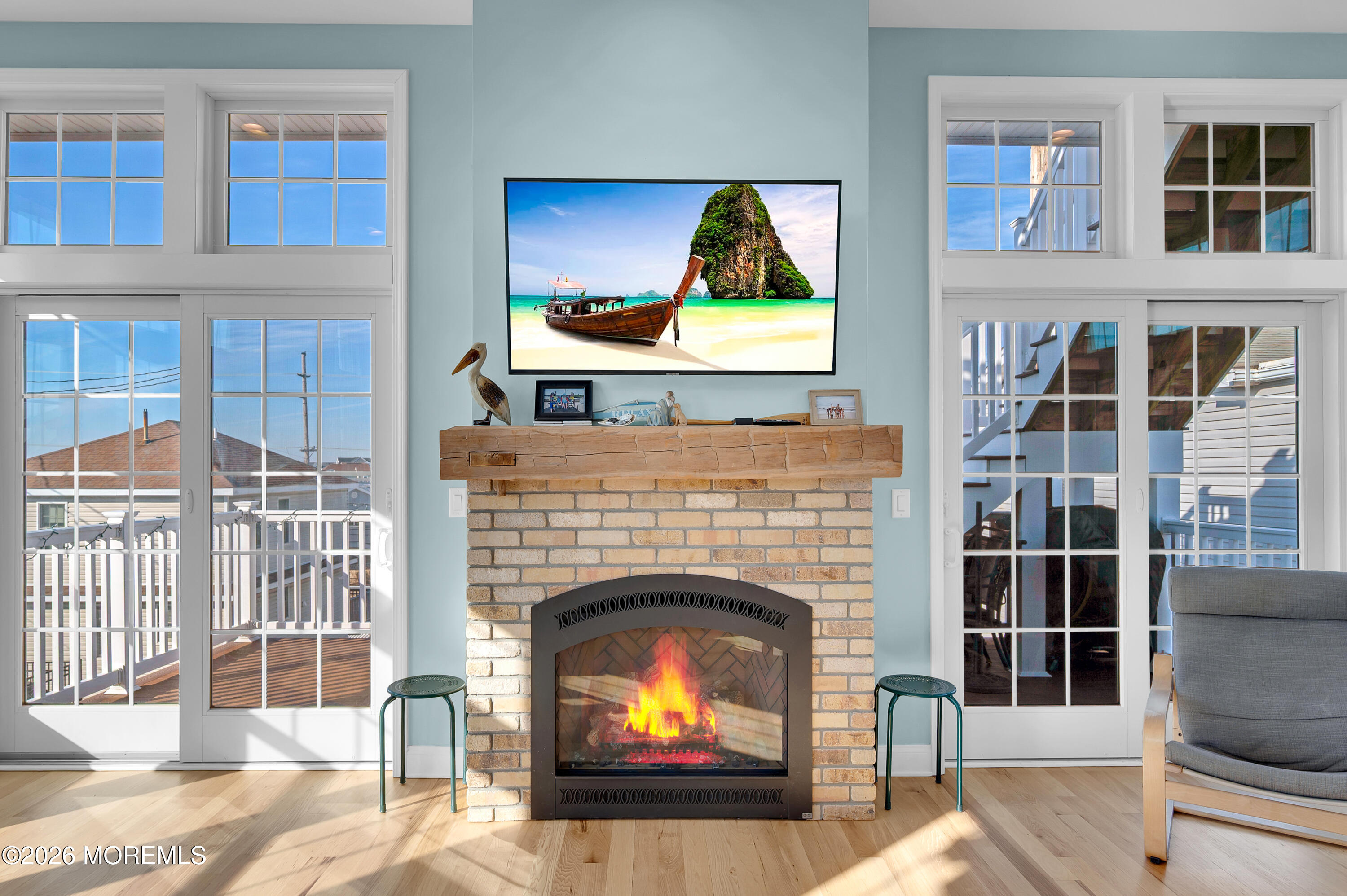 170 West Beach Way Lavallette, NJ 08735 - Photo 22 of 71 a living room with a fireplace a rug and a floor to ceiling window