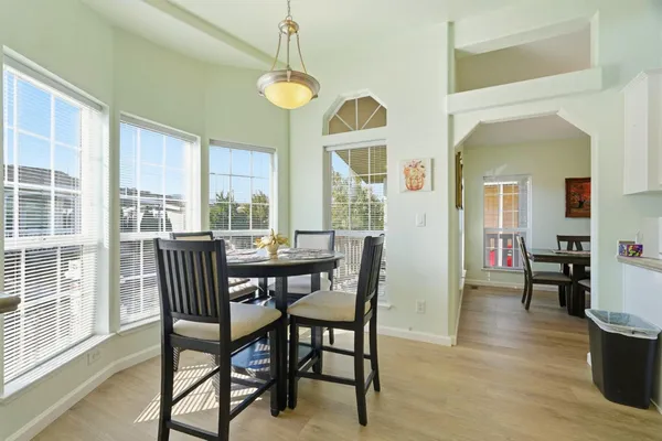 a view of a dining room with furniture window and wooden floor