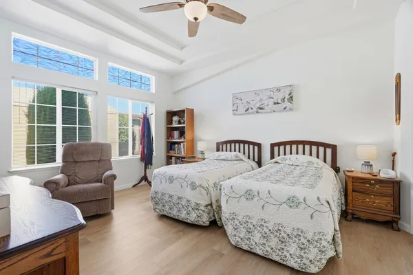 a bedroom with a bed couch and a window