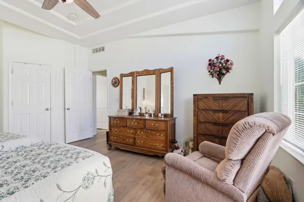 a bedroom with a bed couch and window