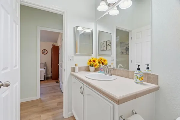 a bathroom with a sink vanity and a mirror