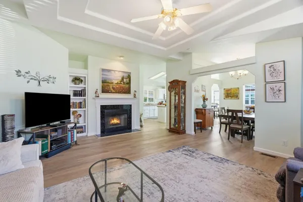 a living room with furniture a fireplace and a flat screen tv