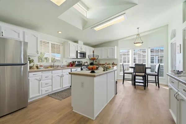 a kitchen with white cabinets and white appliances