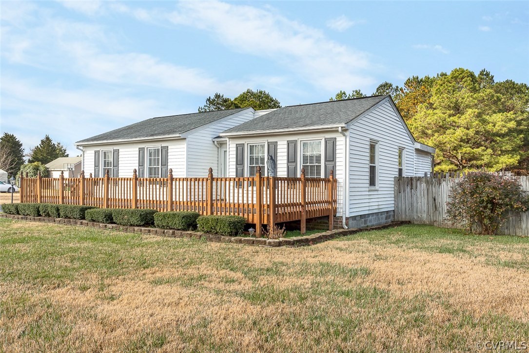 a view of a house with a yard and fence
