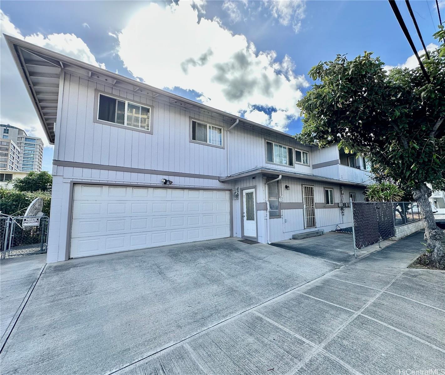 2205 Fern Street Honolulu, HI 96826 - Photo 1 of 13 a view of a house with a garage and yard