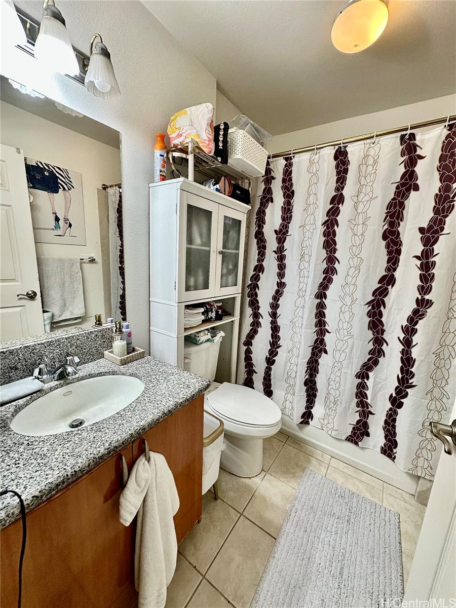 2205 Fern Street Honolulu, HI 96826 - Photo 13 of 13 a bathroom with a granite countertop sink and a mirror