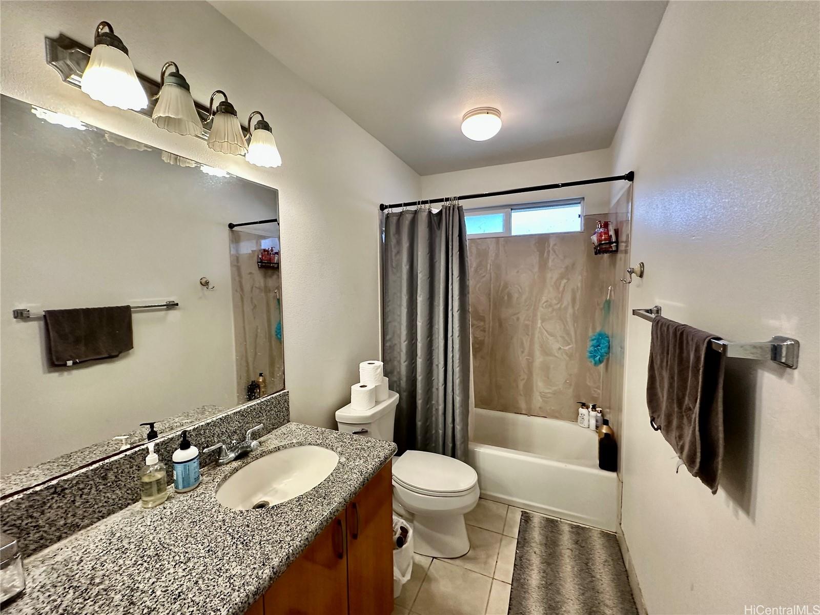 2205 Fern Street Honolulu, HI 96826 - Photo 5 of 13 a bathroom with a granite countertop sink toilet and shower