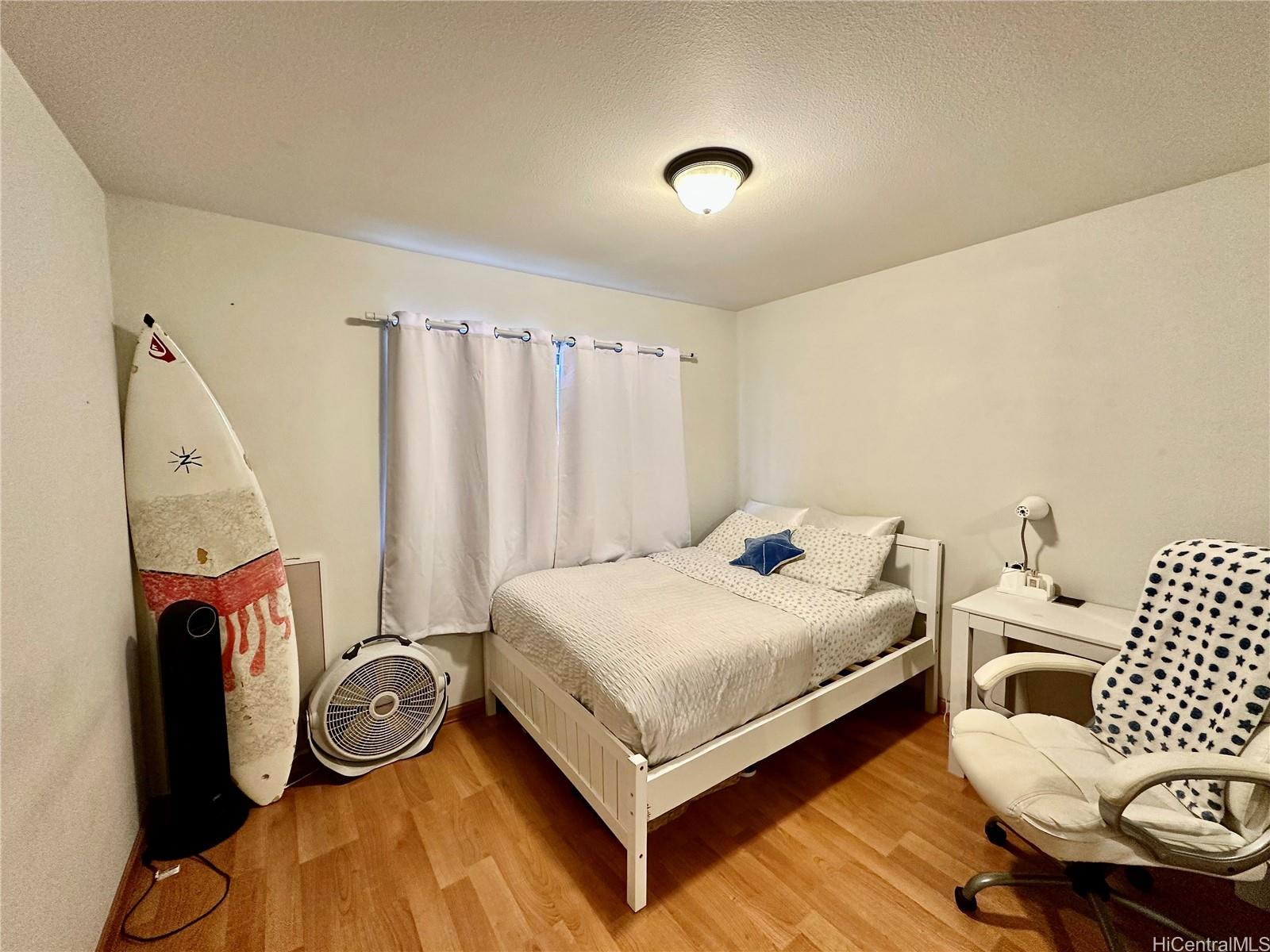 2205 Fern Street Honolulu, HI 96826 - Photo 6 of 13 a bedroom with a bed and a couch
