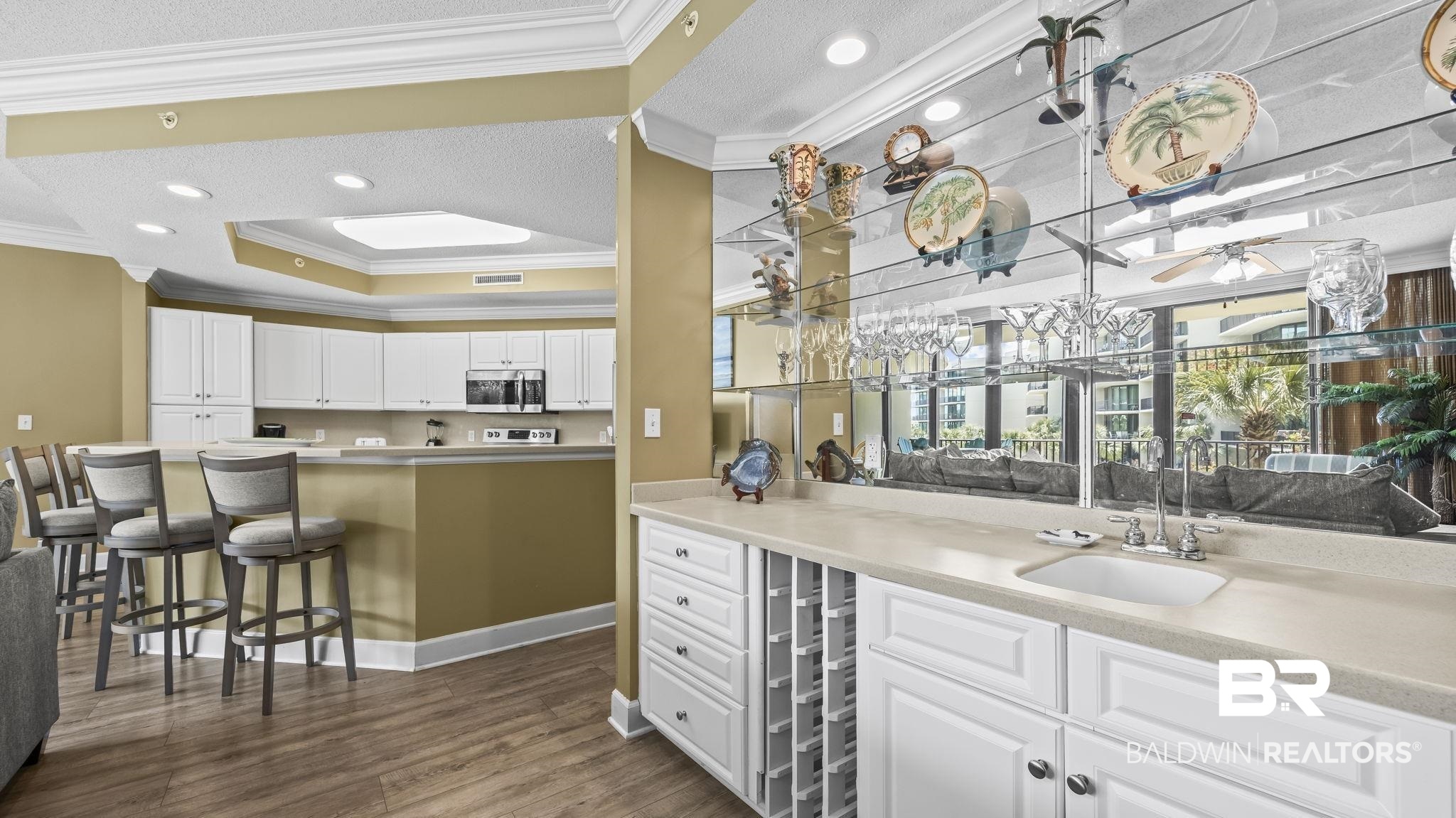 27580 Canal Road, Unit 214 BS 62 Orange Beach, AL 36561 - Photo 6 of 23 White cabinetry, light countertops, recessed lighting, dark wood-style floors, and ornamental molding