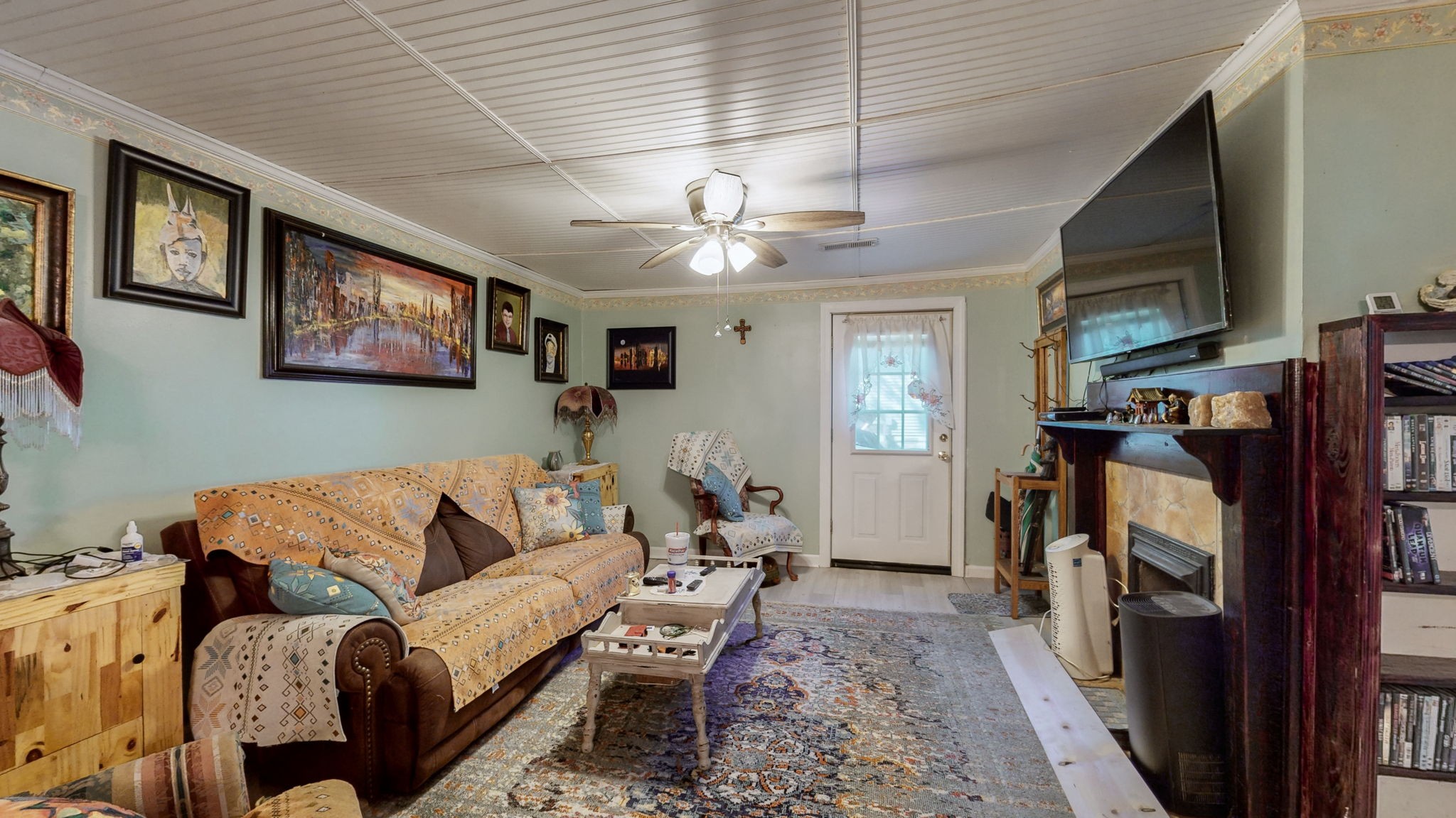 407 Villa Street Murfreesboro, TN 37129 - Photo 8 of 33 a living room with furniture a flat screen tv and a ceiling fan