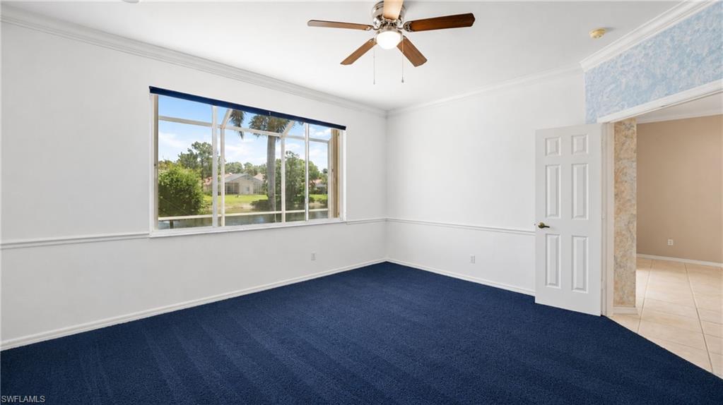 7737 Haverhill Court Naples, FL 34104 - Photo 15 of 37 Room featuring a large multi-pane window overlooking a water feature and distant homes